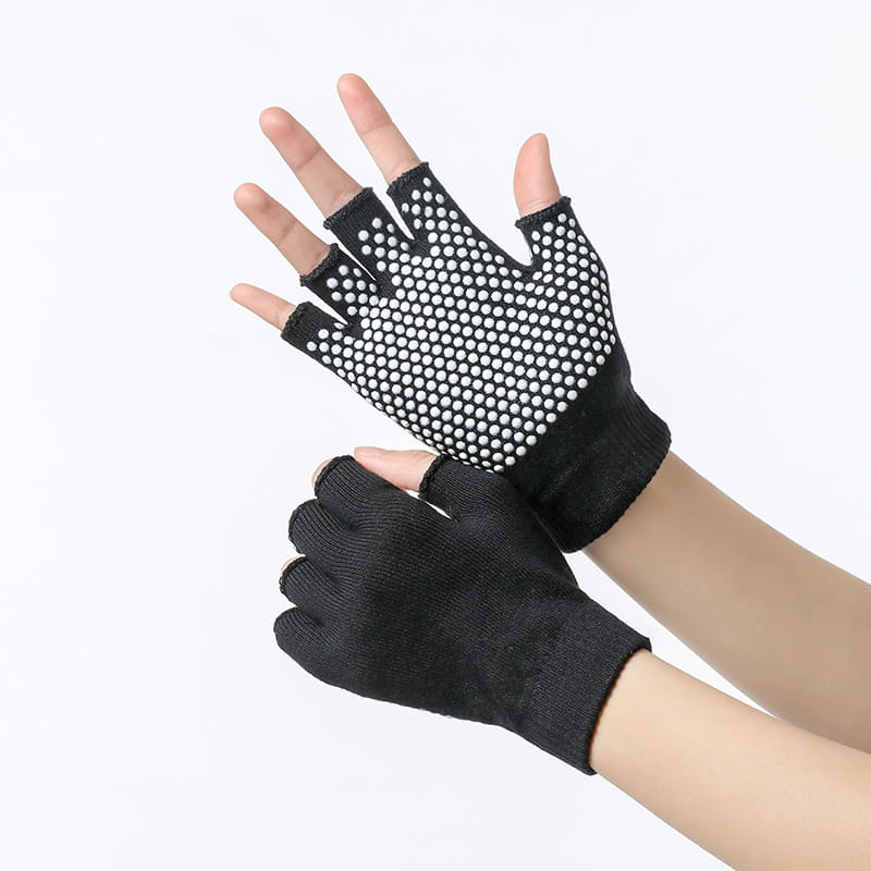 Black fingerless non-slip yoga gloves for women with a textured grip surface featuring white circular dots designed for fitness and weightlifting.