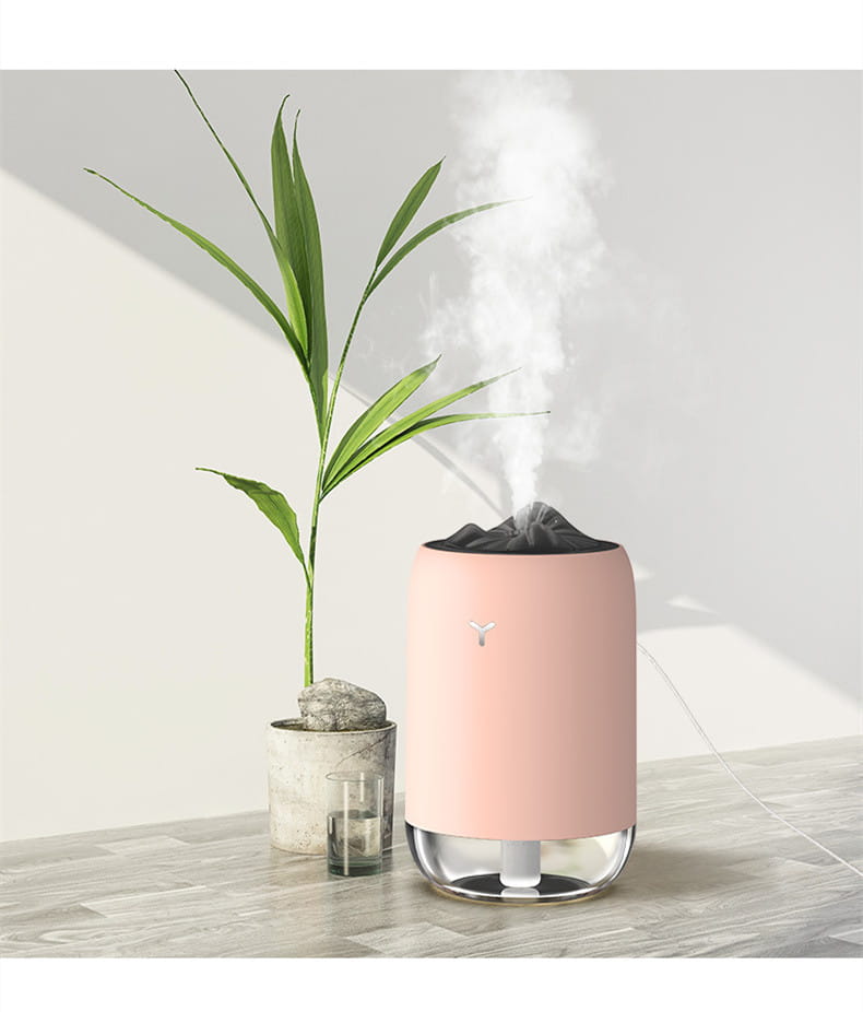 Pink cylindrical magic flame humidifier mini usb ultrasonic aroma diffuser with clear glass base black top emitting mist