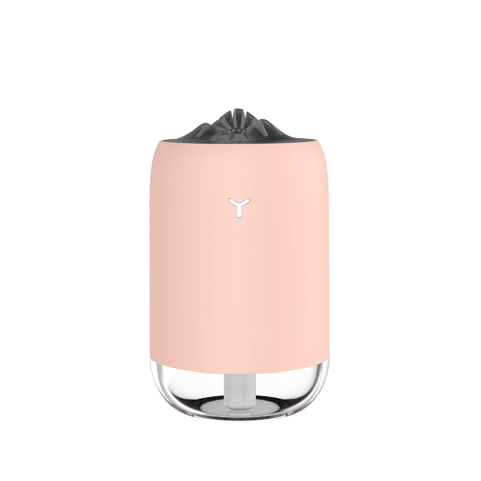 Pastel pink cylindrical magic flame humidifier mini usb ultrasonic aroma diffuser with a clear glass base and black top.