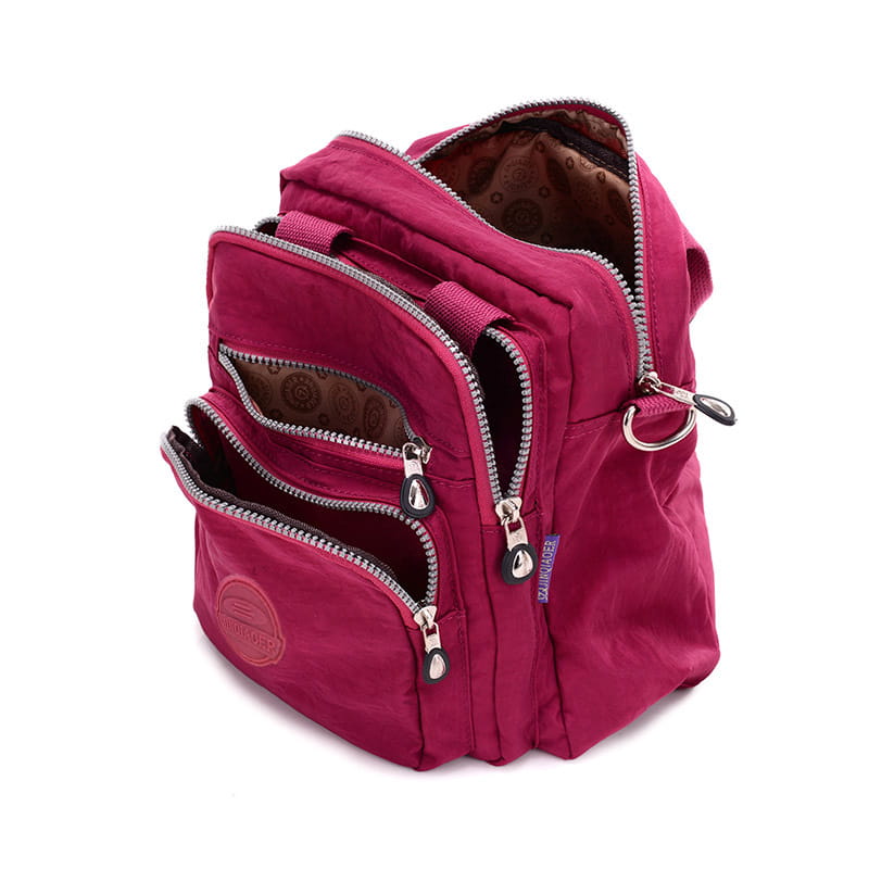 A vibrant magenta nylon crossbody bag 25cm featuring multiple zippered compartments and silver-toned zippers designed for multifunctional use.