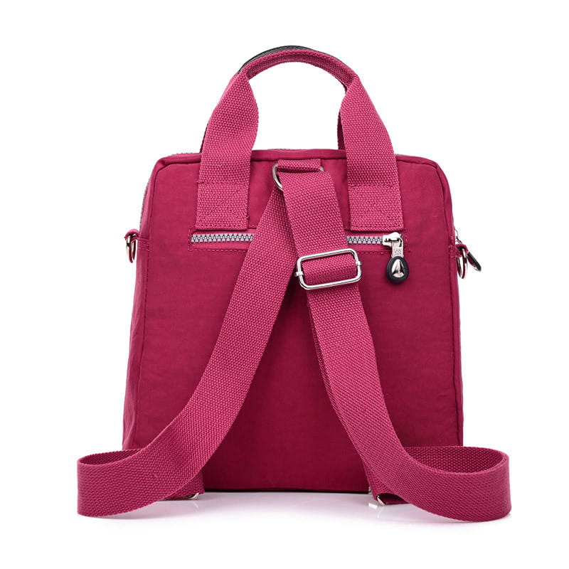 A vibrant magenta multi-functional nylon crossbody bag 25cm featuring adjustable shoulder straps, a top handle, silver zippers, and metal hardware.