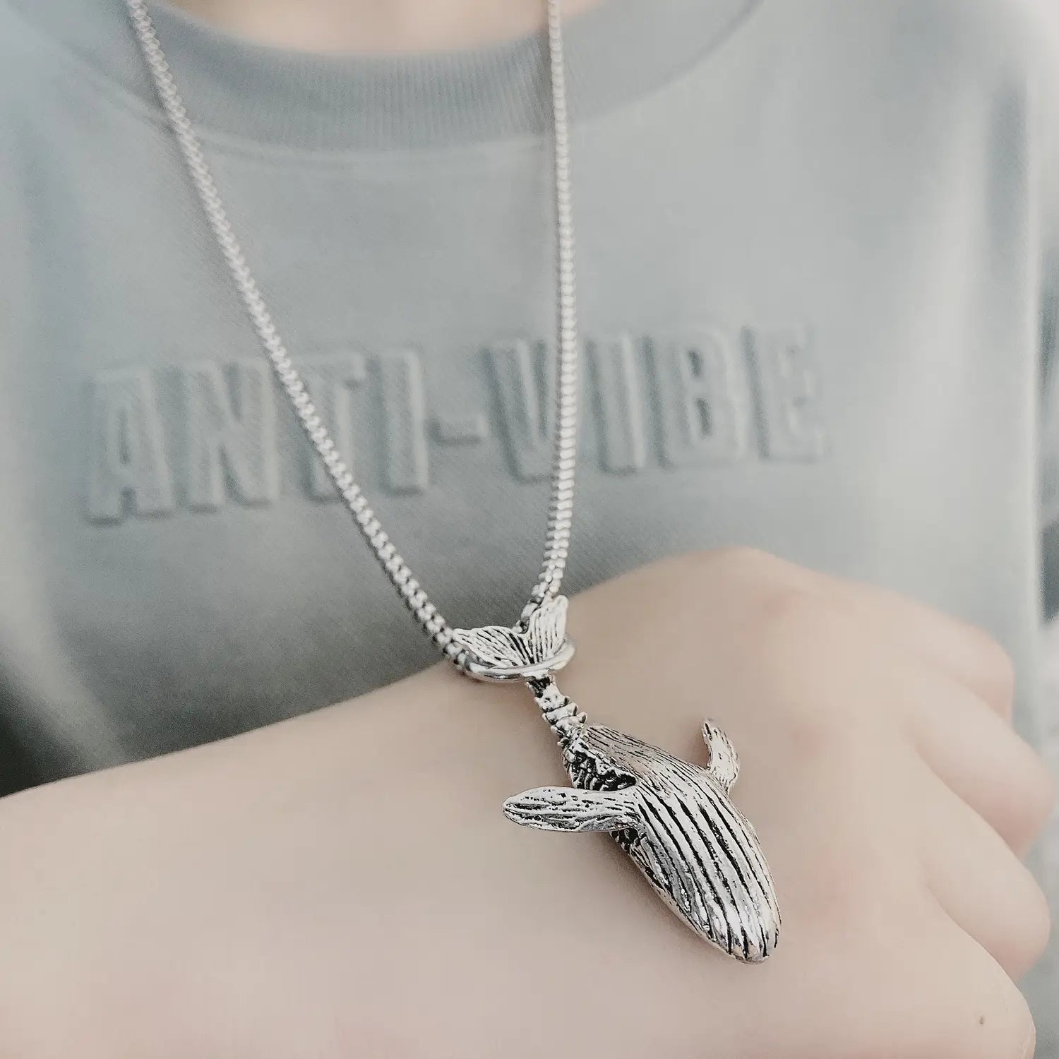 Silver-toned textured silver whale pendant necklace with matching chain made of titanium steel for a hip hop style.