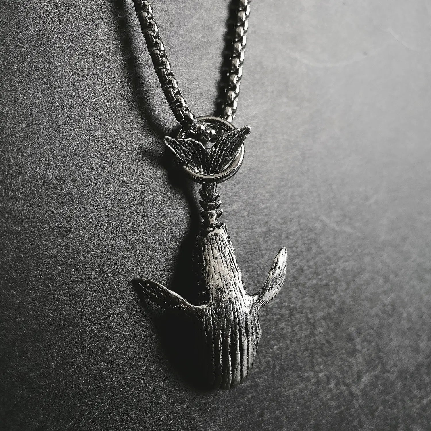 Silver-toned whale pendant necklace made of titanium steel with a detailed textured surface and chain suitable for hip hop style.