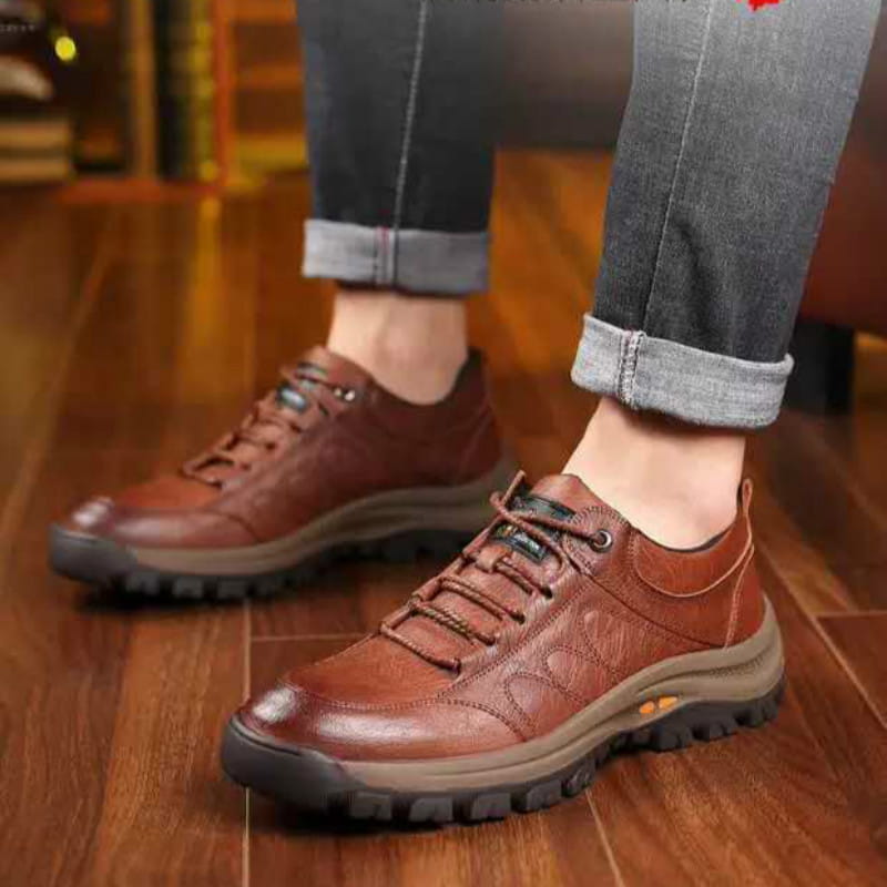Men’s brown leather hiking shoes with lace-up design, rugged sole, and subtle embossed patterns for vintage casual footwear.