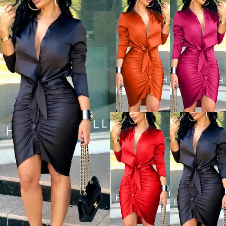 A sleek satin-finish wrap midi shirt dress in black orange or red featuring a deep v-neckline and ruched detailing with long sleeves.