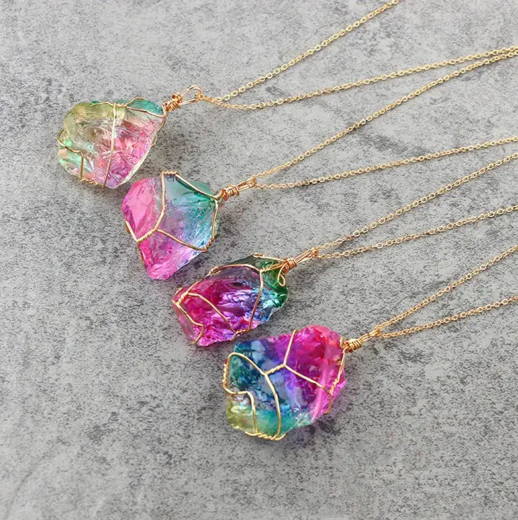 Wire wrapped rainbow quartz crystal pendant necklaces featuring gold-toned chains and rainbow-colored wire wrapping.