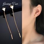 Delicate silver-toned ear cuffs with a sleek elongated triangular design complement minimalist silver and gold triangle tassel dangle earrings.