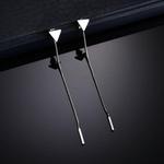 Three sleek metallic clip-on earbuds with minimalist design and silver finish featured alongside minimalist silver and gold triangle tassel dangle earrings.