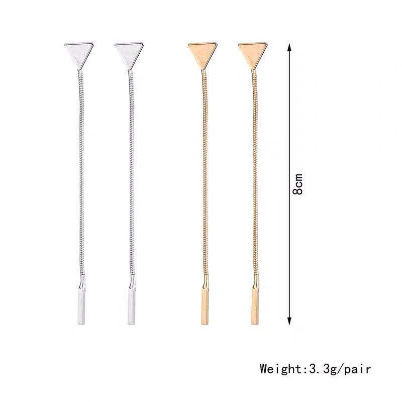 silver and gold triangle-shaped tie bar clips with chain detailing shown alongside minimalist silver and gold triangle tassel dangle earrings