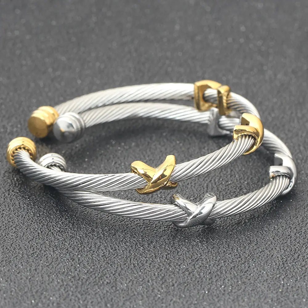 silver and gold-toned twisted cable knot adjustable titanium steel bracelet featuring an x-shaped clasp design