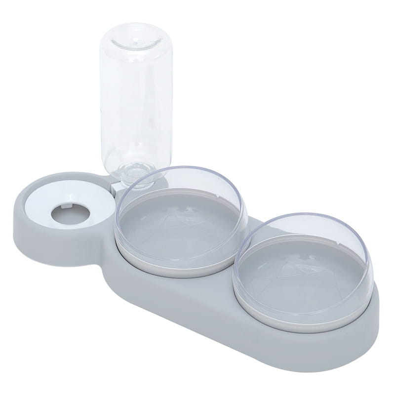 Grauer Kunststoff, automatischer Tierfutter- und Wasserspender als Doppelschale mit zwei klaren Glasschalen und einer transparenten Wasserflasche oben.