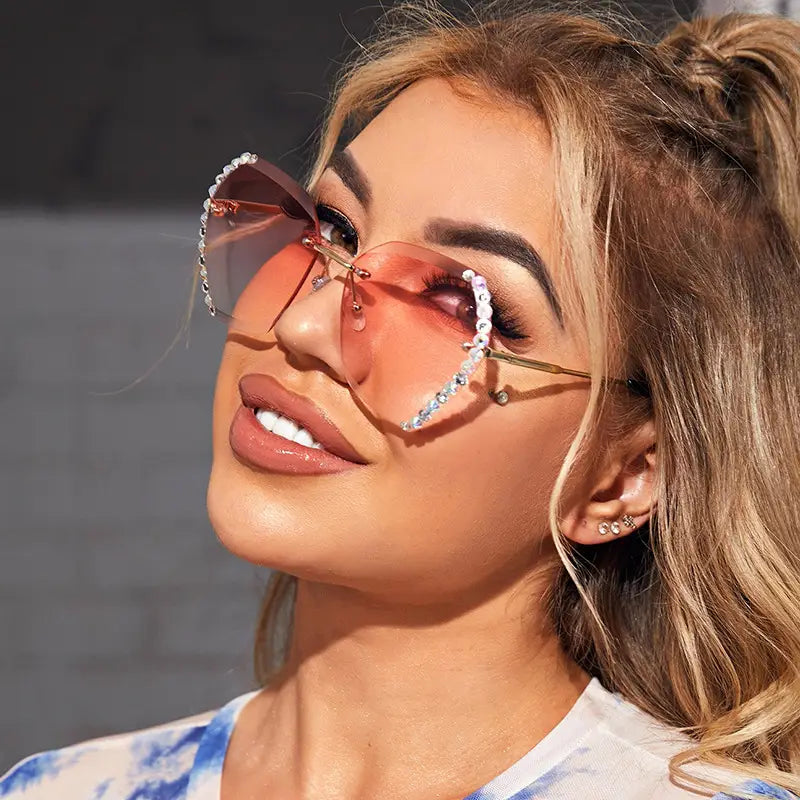 Diamond studded rimless polygonal gradient sunglasses featuring rose gold metal frames and transparent gradient lenses.