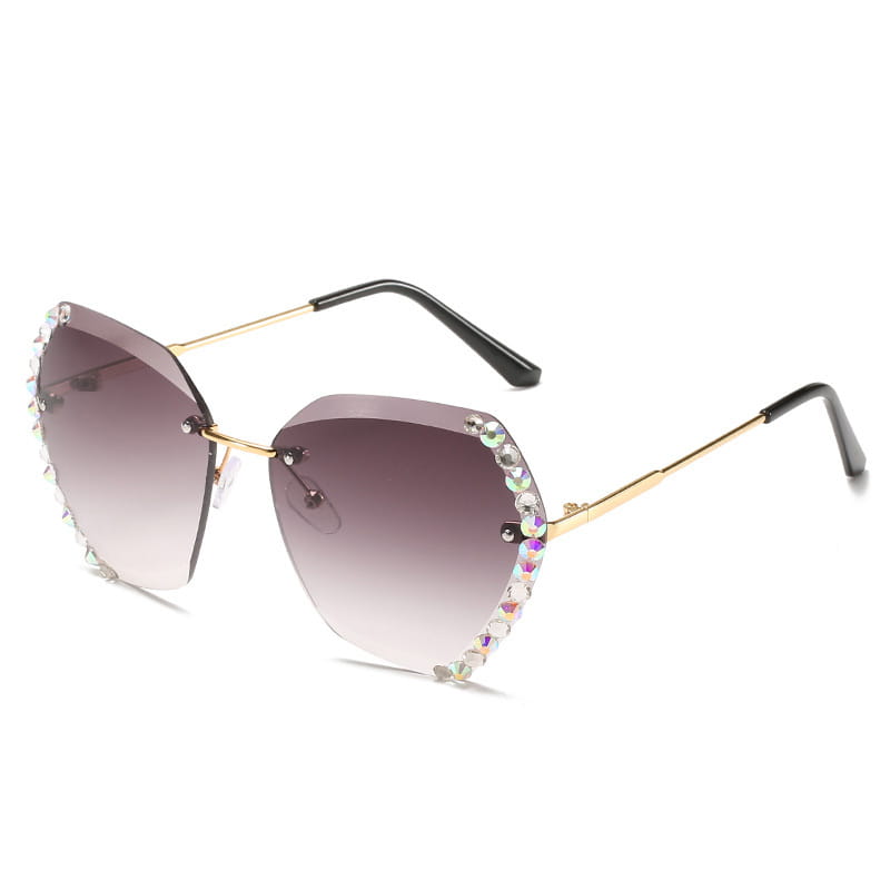 Diamond studded rimless polygonal gradient sunglasses featuring gold-framed cat-eye design with gradient brown lenses and sparkling rhinestone trim along the edges.