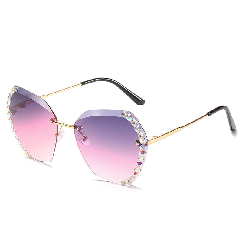 Gold-framed diamond studded rimless polygonal sunglasses with gradient pink and purple lenses adorned with sparkling rhinestones along the edges.