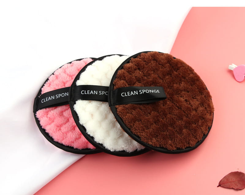 Makeup removing puff 3 pack featuring three circular plush sponges in pink white and brown with black ribbons labeled clean sponge for gentle makeup removal.