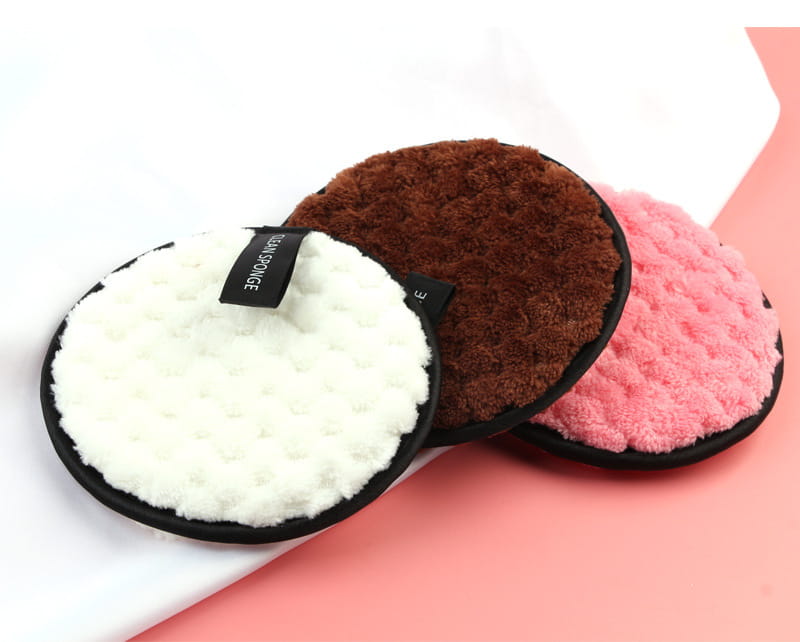 makeup removing puff 3 pack featuring three circular sponges in white brown and pink with black rims for gentle facial cleansing and exfoliation.
