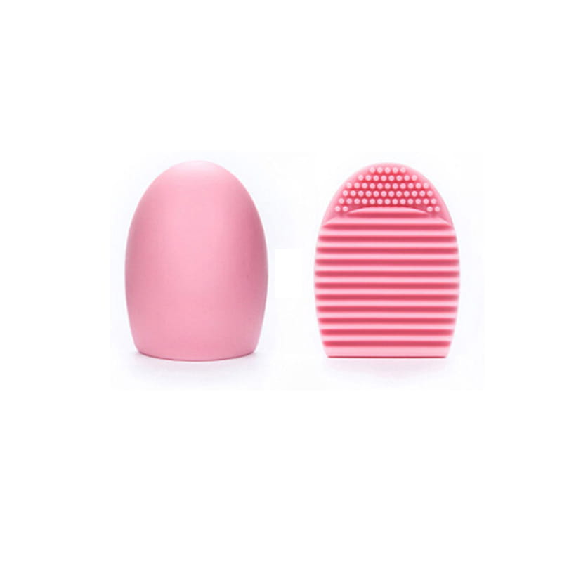 Pink silicone makeup brush cleaner silicone egg scrubbing tool with a smooth rounded handle and textured bristle head featuring horizontal ridges and a dotted top.