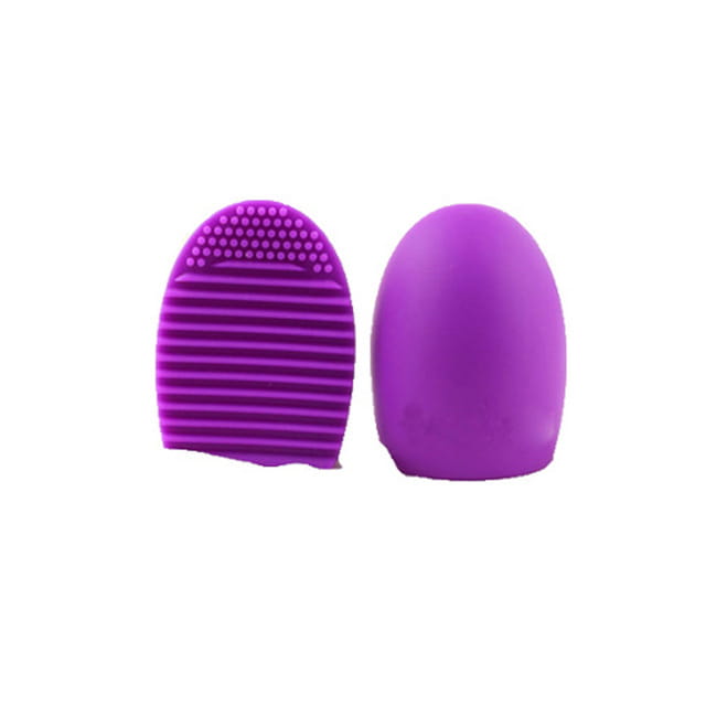 Purple silicone eyelash brush with a textured ridged surface and rounded handle designed as a makeup brush cleaner silicone egg scrubbing tool.