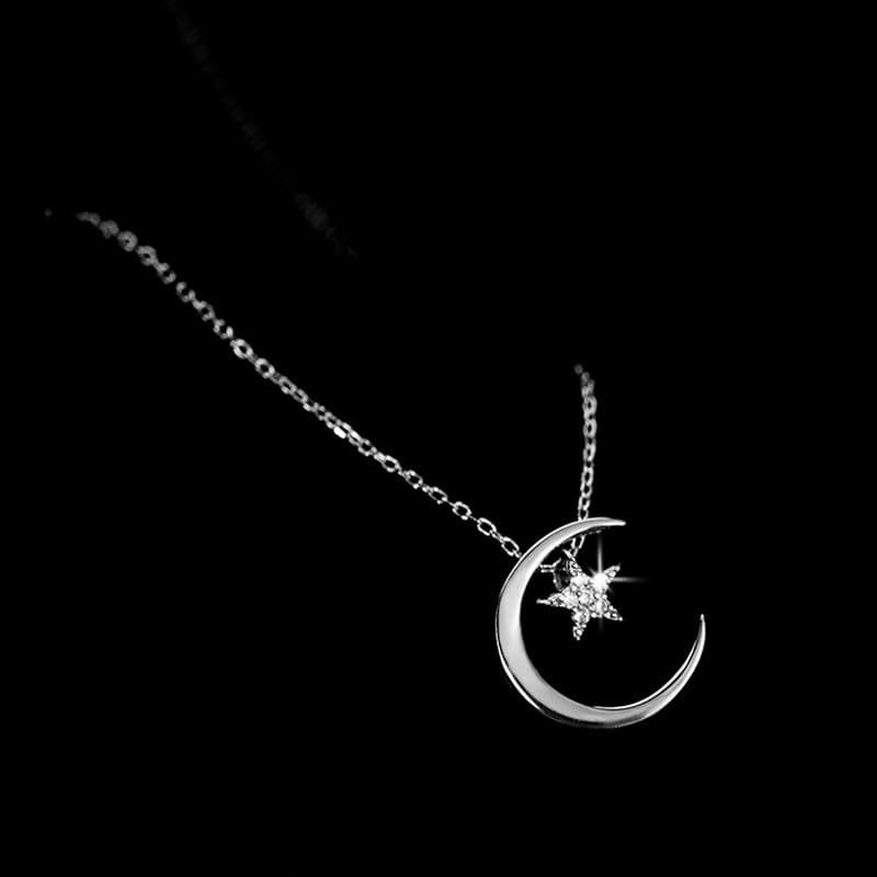 Sterling silver crescent moon pendant necklace featuring a sparkling star charm in silver.