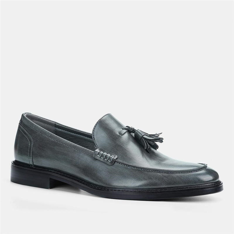 Men’s polished dark gray leather tassel loafer with stitched detailing and composite soles.