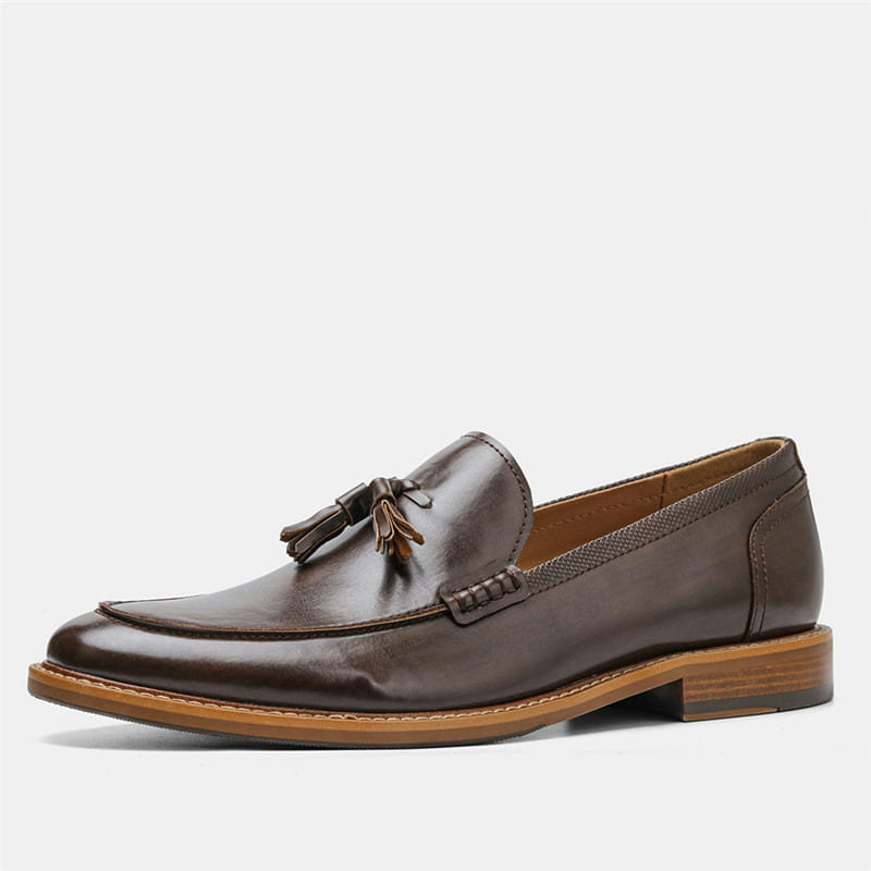 Men’s polished leather tassel loafers in brown with a polished finish and contrasting tan composite soles.