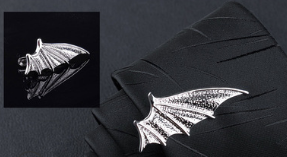 silver bat-shaped lapel pin with a textured metallic finish from the men’s airplane tie clip and lapel pin gift set