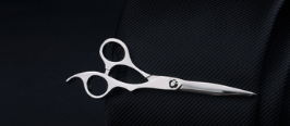 Silver hairdressing scissors with sleek polished blades and ergonomic handles featured alongside a men’s airplane tie clip and lapel pin gift set.