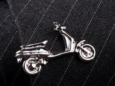 Silver scooter-shaped lapel pin with polished metallic finish and detailed design included in men’s airplane tie clip and lapel pin gift set