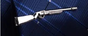 silver metallic rifle-shaped lapel pin with detailed engravings and textured barrel from men’s airplane tie clip and lapel pin gift set