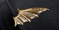 Golden metallic bat-shaped lapel pin with intricate wing detailing from the men’s airplane tie clip and lapel pin gift set.