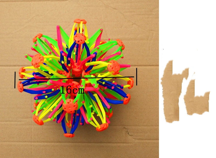 Jouet de balle magique à expansion colorée en forme de sphère télescopique constitué de plastique multicolore, avec des segments épineux néon vert, rose, bleu et jaune rayonnant à partir d’un noyau central orange.