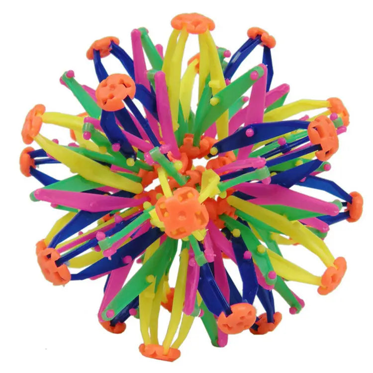 Jouet de balle magique à expansion en forme de sphère télescopique coloré et éclatant, avec des pointes en plastique vert, bleu et rose, ainsi que des pointes en plastique orange, rayonnant à partir d’un hub central.