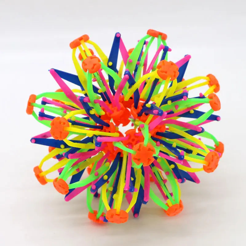 Jouet toupie en plastique aux couleurs néon éclatantes, avec des bras s’emboîtant et des connecteurs orange, présenté comme la balle magique à expansion, en sphère télescopique colorée.