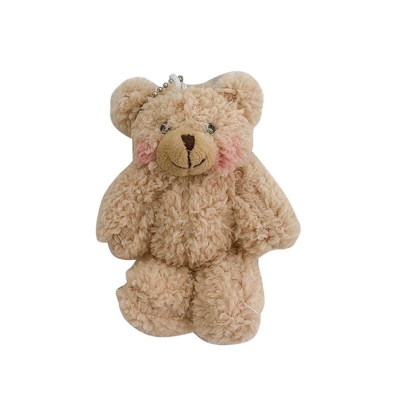 Ein weicher, flauschiger Teddybär-Schlüsselanhänger in Beige mit pinken Wangen und einer braunen Nase als niedliche Mini-Puppe-Anhängerfigur.