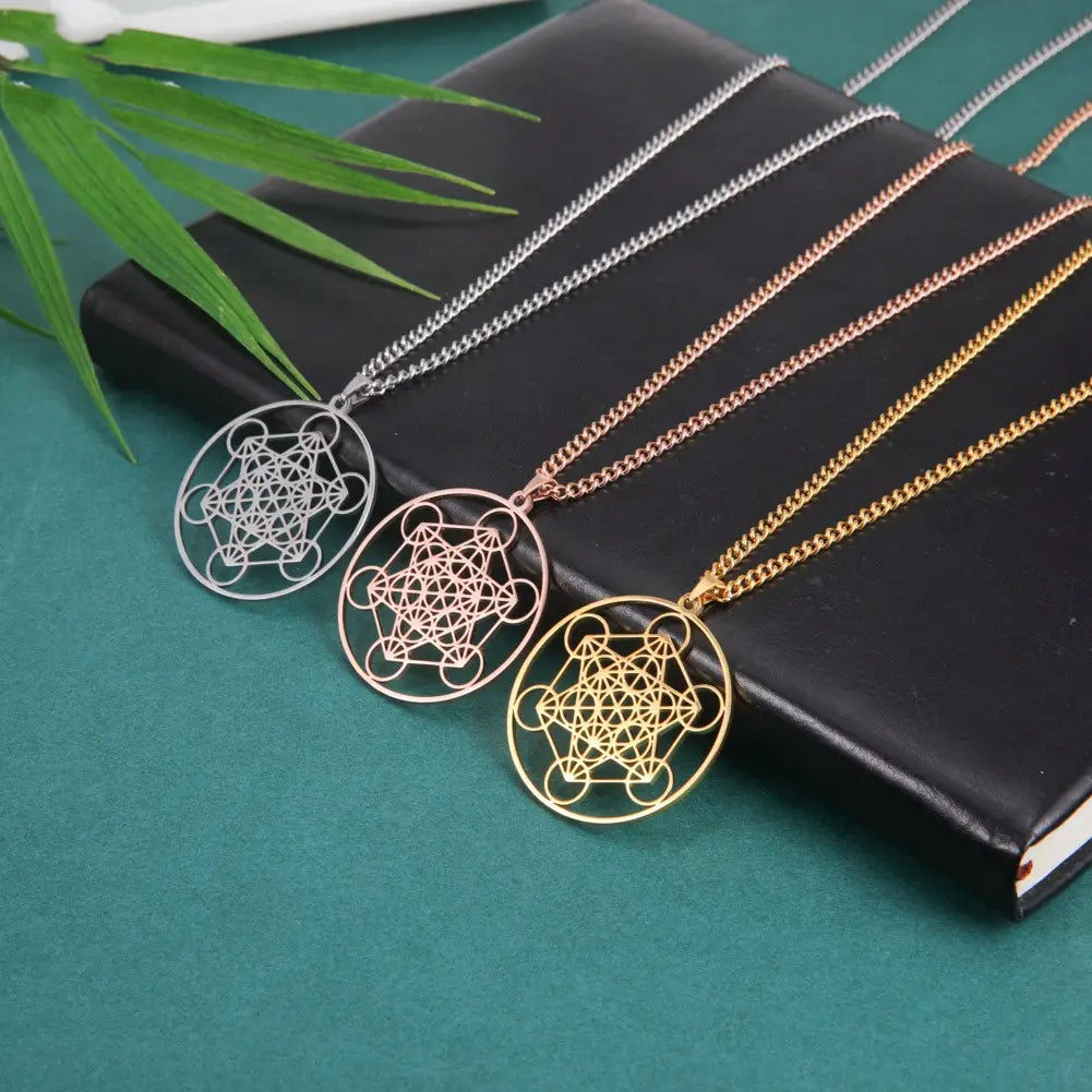 three metallic geometric pendant necklaces in silver, rose gold, and yellow gold finishes featuring the metatron cube design crafted from stainless steel for the moon goddess necklace collection.