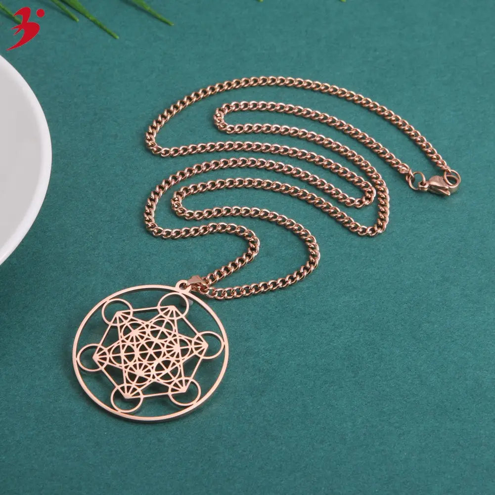 Rose gold-colored stainless steel necklace featuring a circular pendant with an intricate metatron cube geometric design for a moon goddess theme.