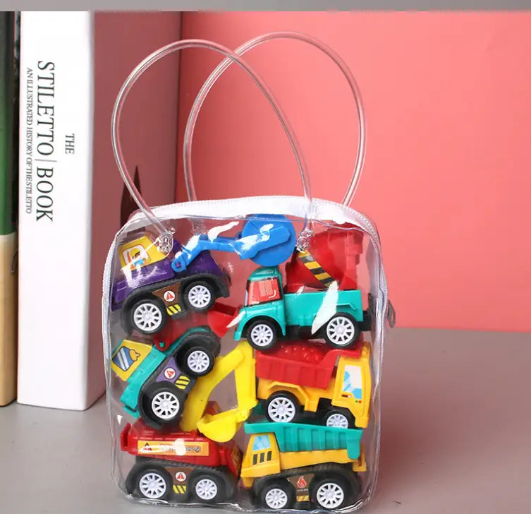 A clear plastic bag with transparent handles containing a pull back fire truck and engineering vehicle toy set in blue green yellow and red colors.