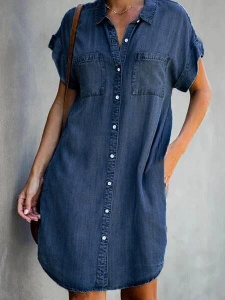 A navy blue slim fit short sleeve button front denim midi dress with two chest pockets.