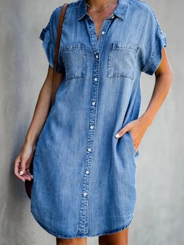 A medium-wash denim midi dress features slim fit, short rolled-up sleeves, button front, and two front patch pockets.