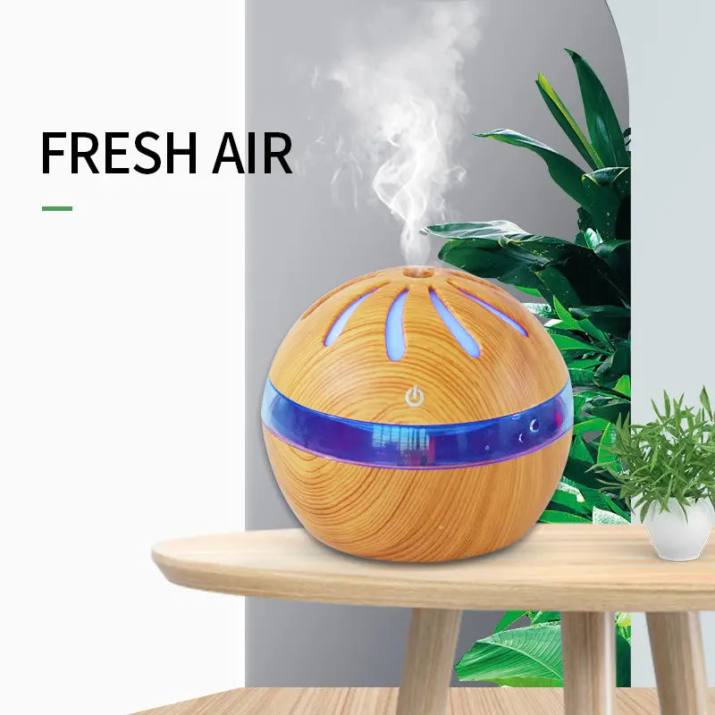 Windmill wooden spherical aroma diffuser with a blue glowing band, slotted top, and mist emission, featuring a 1-liter capacity and USB power.