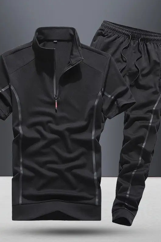 men summer athletic short sleeve two piece set featuring a black athletic tracksuit with subtle gray piping along the seams and a quarter-zip collar designed for active use.