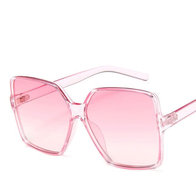 Gafas de sol vintage geométricas extragrandes con protección UV400 y lentes con degradado, con lentes con degradado rosa y montura geométrica transparente.