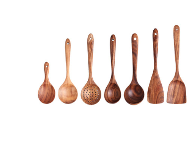 Set of eight teak wood kitchen utensils including spoons, a slotted spoon, and spatulas in natural wood color for cooking and serving.