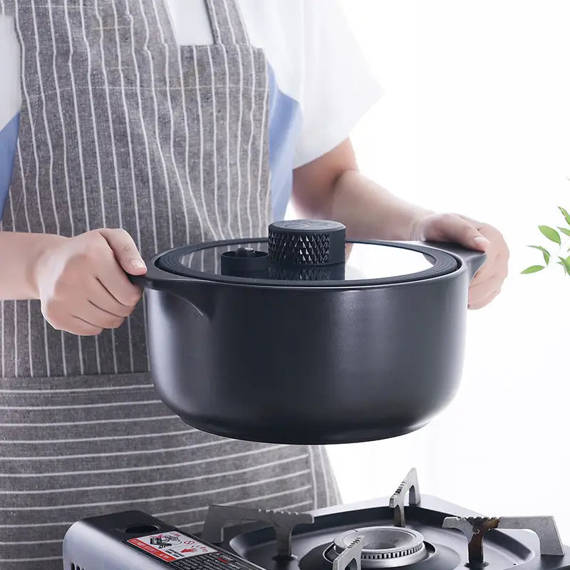 Black ceramic micro pressure anti overflow casserole pot with matching lid and textured knob handle.