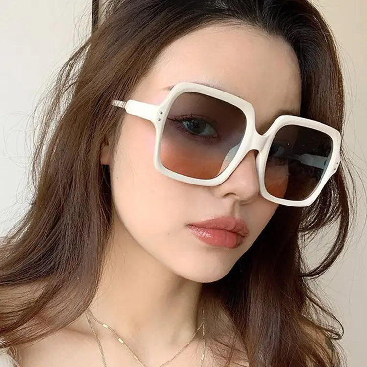 Oversized square fashion sunglasses with white translucent frames and gradient brown lenses.