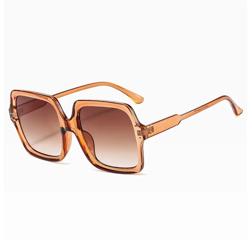 Oversized square fashion sunglasses with tortoiseshell translucent frames and gradient brown lenses.
