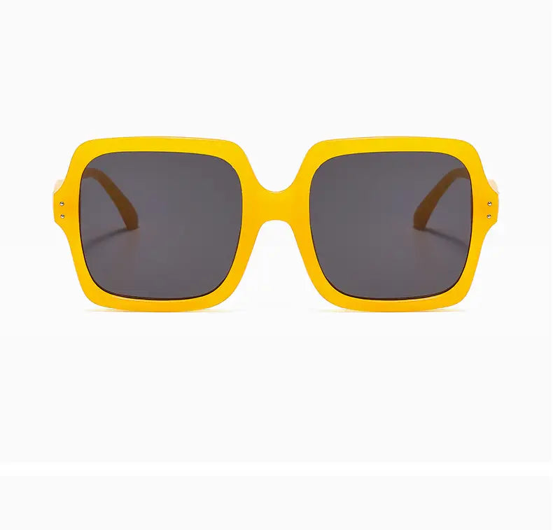 Oversized square fashion sunglasses with bright yellow translucent frames and dark gray lenses.