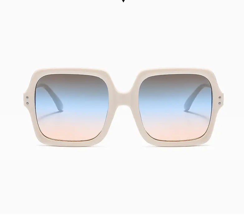 Cream-colored oversized square fashion sunglasses with translucent frames and gradient blue to pink lenses.