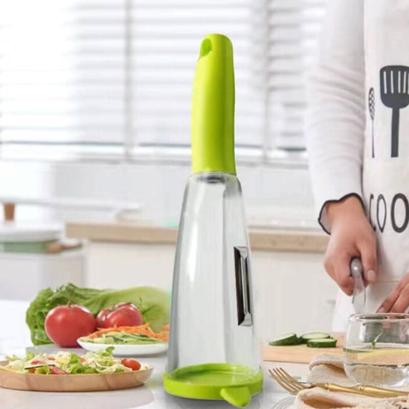Distributeur d’huile en verre transparent avec une poignée et une base en silicone vert citron, conçu pour s’harmoniser avec un éplucheur de légumes avec boîtier de rangement et lame en acier inoxydable.