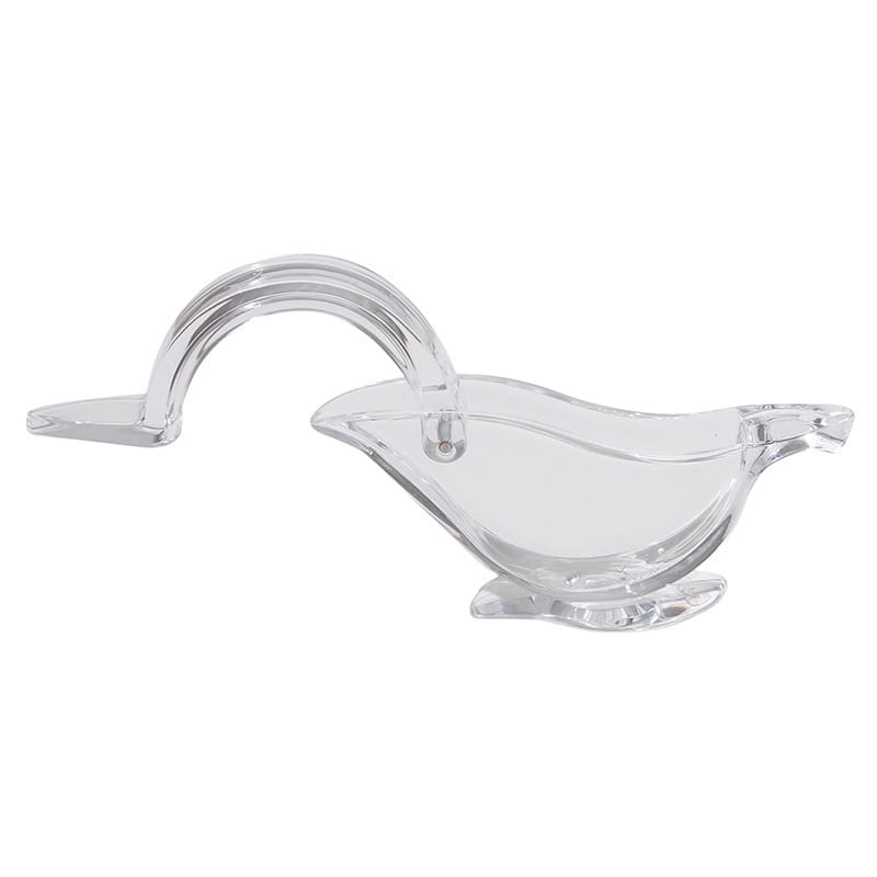 Saucière en verre transparent, avec une poignée courbée et des contours lisses, présentée à côté d’un outil presse-agrumes manuel en acrylique « oiseau » pour agrumes.